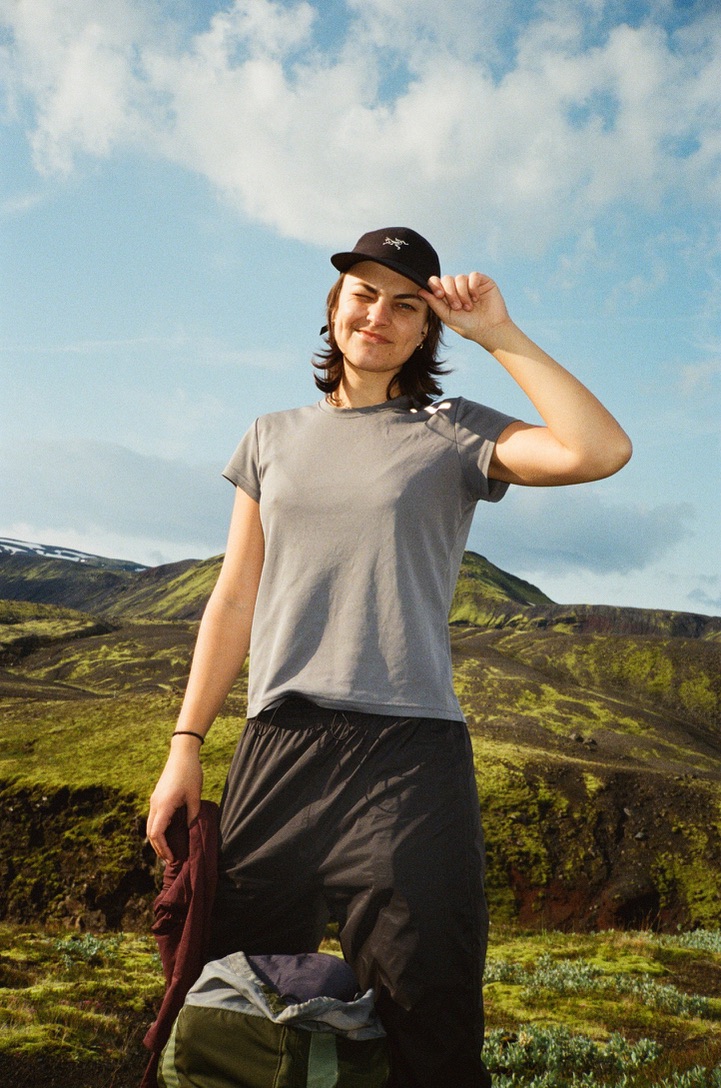 Sage Taber in a black cap among green hills